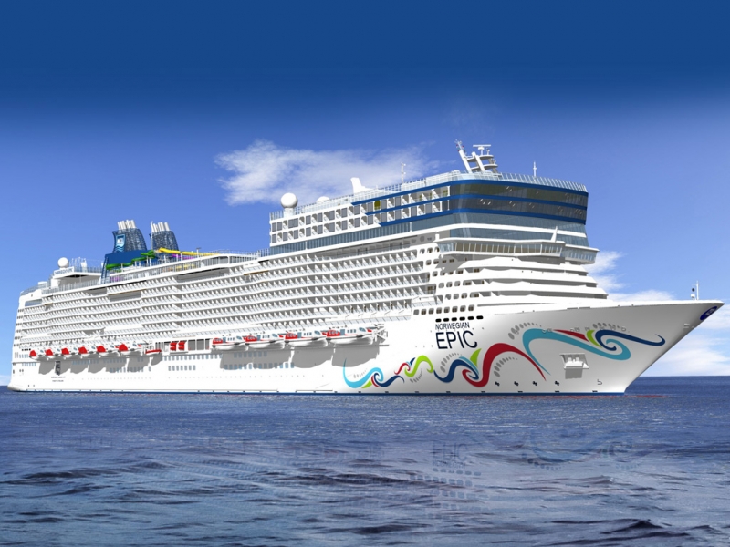 Travel X A large white cruise ship with colorful wave designs on its hull is sailing on the ocean under a clear blue sky. Book your trip with Travel X for an unforgettable vacation. Book Your Trip With Travel X