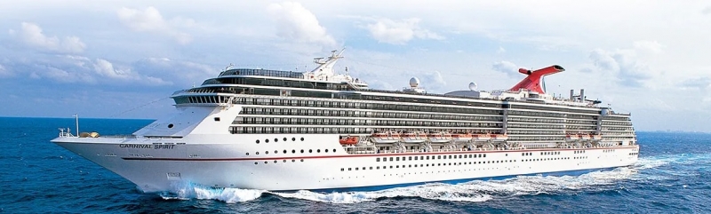 Travel X A large white cruise ship with multiple decks and lifeboats sails on the ocean under a partially cloudy sky. The ship, which features a red and black funnel, looks like the perfect floating resort. Book your trip today with Travel X for an unforgettable ocean adventure. Book Your Trip With Travel X