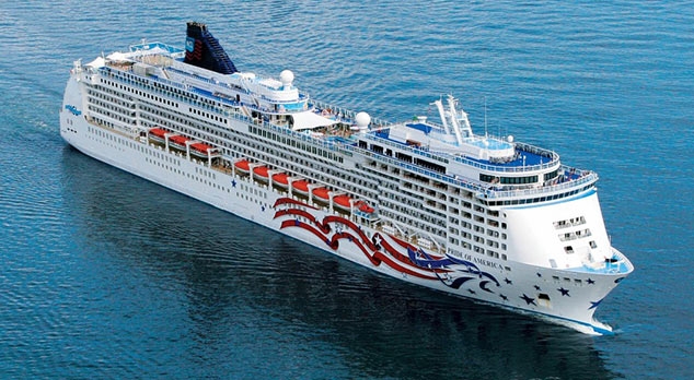 Travel X A large white cruise ship with red and blue decorative designs sails through calm blue waters, offering a perfect vacation. Book your trip now for an unforgettable resort experience on the open sea. Book Your Trip With Travel X