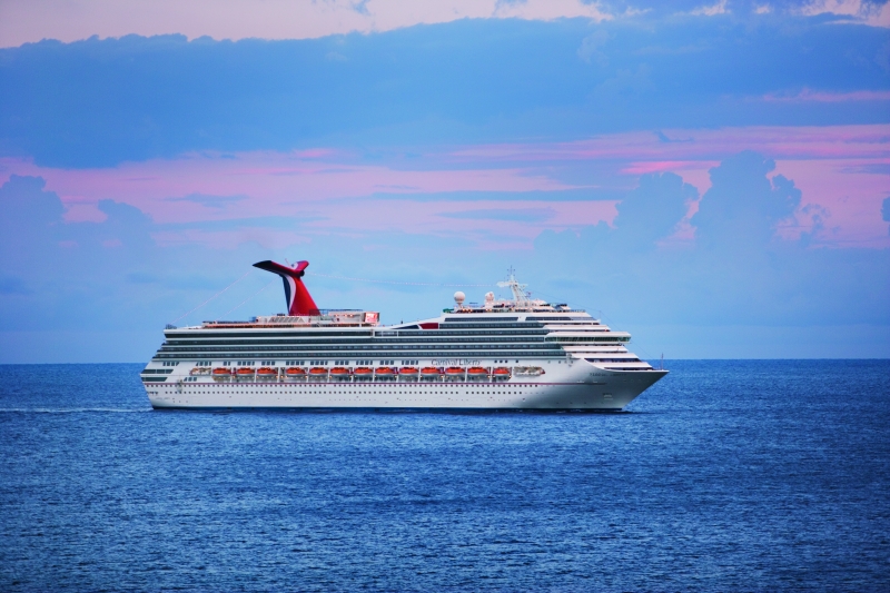 Travel X A large white cruise ship sails on the ocean under a sky with pink and blue hues, promising the perfect start to your dream vacation. Book your trip with Travel X today! Book Your Trip With Travel X