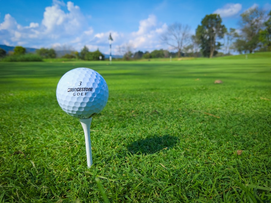 Travel X A close-up of a Bridgestone golf ball on a tee, set on a lush green golf course under a partly cloudy sky—a perfect scene to book your trip and start your travel adventure. Book Your Trip With Travel X