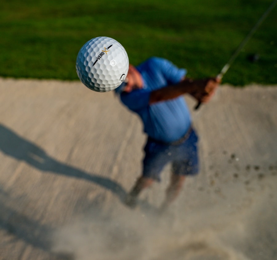 Travel X A person in a blue shirt and shorts swings a golf club, hitting a golf ball out of a sand trap with grass in the background, enjoying their vacation at a beautiful resort. Book Your Trip With Travel X